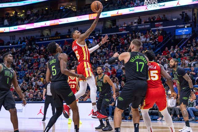 Nov 4, 2023; New Orleans, Louisiana, USA;  Atlanta Hawks guard Dejounte Murray (5) drives to the basket against New Orleans Pelicans forward Herbert Jones (5) during the first half at Smoothie King Center.