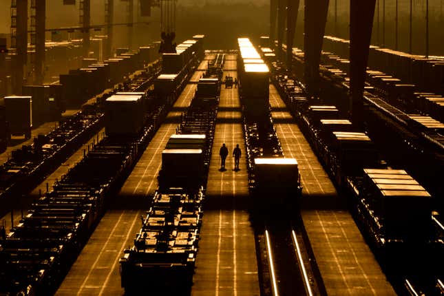 Workers walk among shipping containers at a BNSF intermodal terminal, Wednesday, Jan. 3, 2024, in Edgerton, Kan. On Friday, the U.S. government issues its December jobs report. (AP Photo/Charlie Riedel)