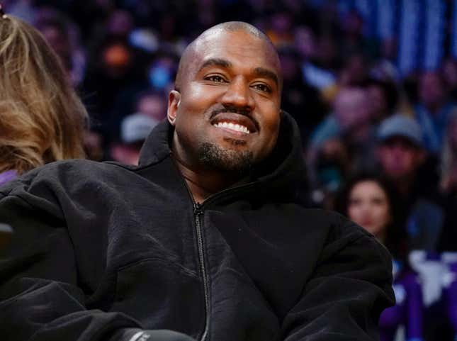 FILE - Kanye West, known as Ye, watches the first half of an NBA basketball game between the Washington Wizards and the Los Angeles Lakers, March 11, 2022, in Los Angeles. Adidas CEO Bjørn Gulden said on a recent podcast that he didn&#39;t believe that Ye “meant what he said” when he made a series of antisemitic remarks in 2022. (AP Photo/Ashley Landis, File)