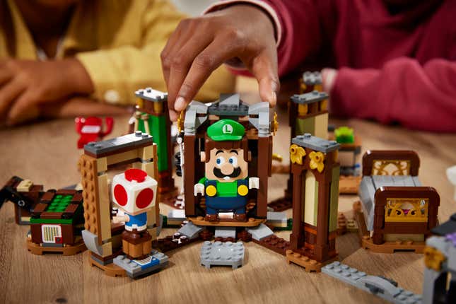 Kids playing with Lego Luigi and Lego Toad in the Luigi's Mansion Haunt-and-Seek expansion set. 