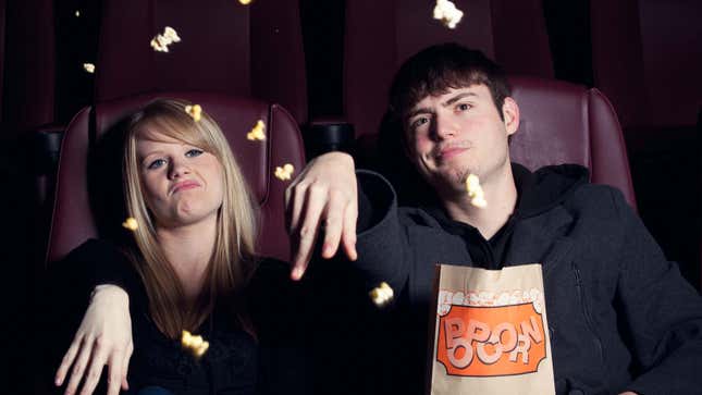 An image shows kids tossing popcorn in a movie theater. 