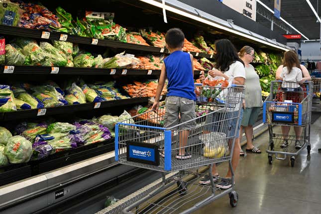 Consumers shop in the produce section of a Walmart in Burbank, California. 