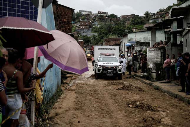 A vehicle of the forensic institute leaves with the body of a victim recovered from the mud a day after a landslide in Recife, Brazil. 