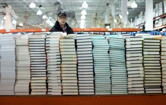A customer looks through stacks of books while shopping at a Costco store in Arlington, Virginia. 