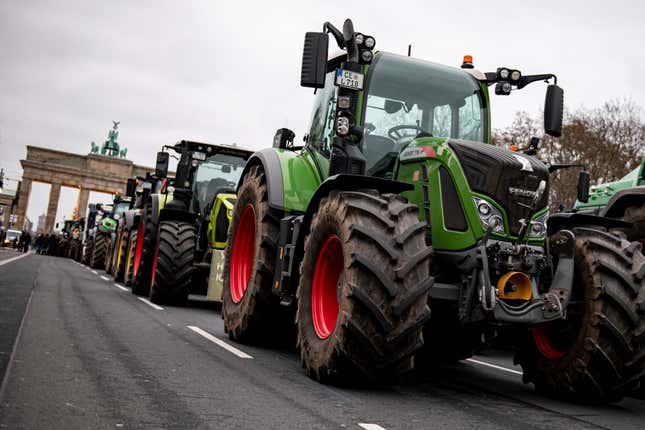 FILE - Farmers with tractors take part in a protest rally organized by the German Farmers&#39; Association in Berlin, Germany, Monday, Dec. 18, 2023. The German government on Thursday watered down cost-saving plans that have infuriated farmers, announcing that it will give up a proposal to scrap an exemption from car tax for farming vehicles and will stagger cuts to tax breaks for diesel used in agriculture. (Fabian Sommer/dpa via AP, File)