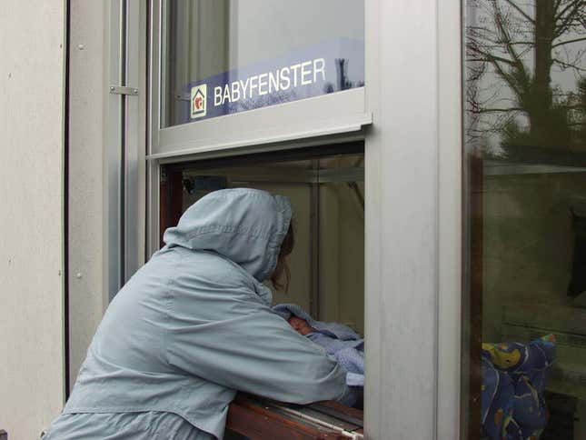 An actor plays the role of a mother and her unwanted newborn at a ”baby window” in Einsiedeln, Switzerland.