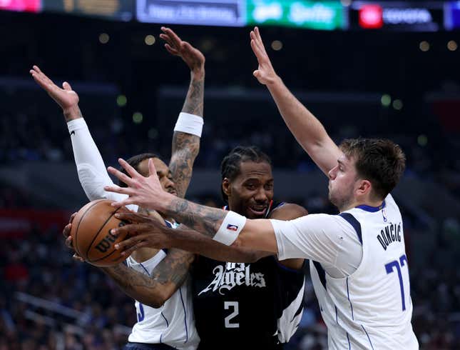LOS ANGELES, CALIFORNIA - APRIL 23: Kawhi Leonard #2 of the LA Clippers looks to pass out of a trap by Luka Doncic #77 and P.J. Washington #25 of the Dallas Mavericks during the first half at Crypto.com Arena on April 23, 2024 in Los Angeles, California. User is consenting to the terms and conditions of the Getty Images License Agreement. (Photo by Harry How/Getty Images)