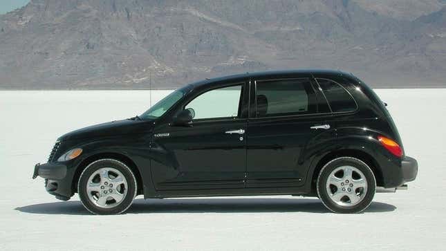 A black PT Cruiser on a dried lake bed