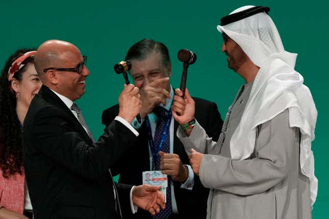 COP28 President Sultan al-Jaber and United Nations Climate Chief Simon Stiell both hold gavels at the end of the COP28 U.N. Climate Summit, Wednesday, Dec. 13, 2023, in Dubai, United Arab Emirates. (AP Photo/Kamran Jebreili)