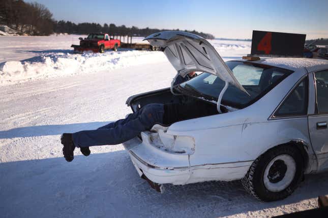 RICE LAKE, WISCONSIN - FEBRUARY 20: Mark Barta repairs his race car after a race on February 20, 2021 at Rice Lake, Wisconsin.  The races are organized by Rice Lake Ice Racing on an oval track located on ice on Rice Lake in northern Wisconsin.