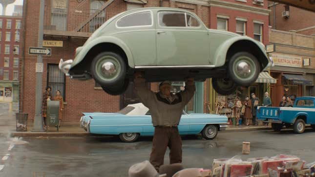 The Thing raises a car above his head.
