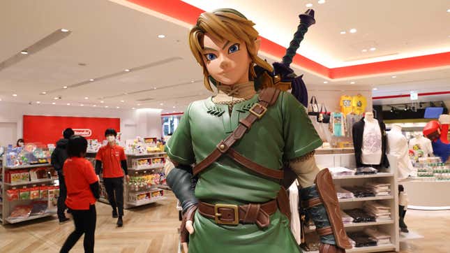 A statue of Link stands in the middle of a Nintendo store.