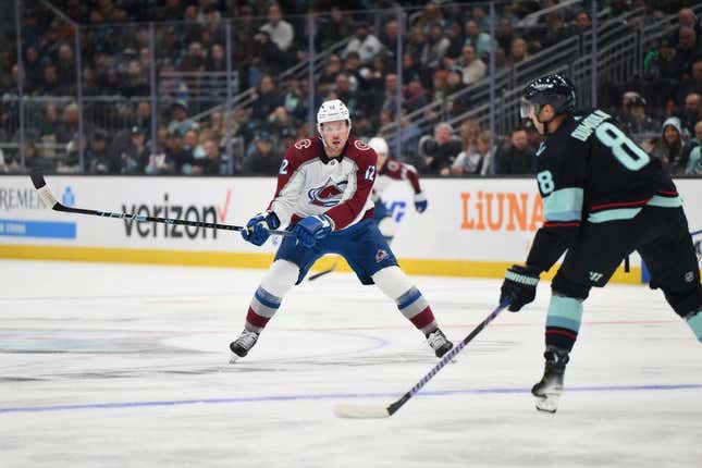 Oct 17, 2023; Seattle, Washington, USA; Colorado Avalanche center Ryan Johansen (12) defends Seattle Kraken defenseman Brian Dumoulin (8) during the first period at Climate Pledge Arena.