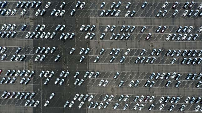 A photo of a lot full of new cars all in boring colors. 