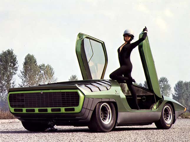 Rear 3/4 of the green Alfa Romeo 33 Carabo concept with the doors open and a model posing in the door opening