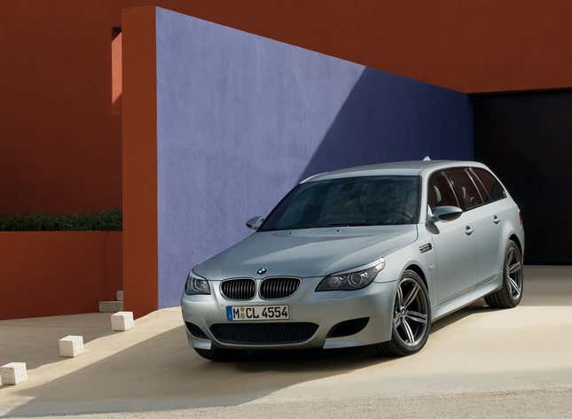 BMW M5 Touring in a colorful home's driveway