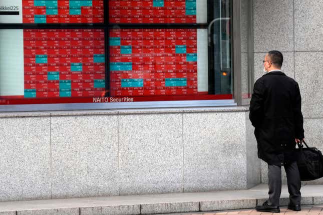 FILE - A person looks at an electronic stock board showing Japan&#39;s stock prices at a securities firm Friday, March 1, 2024, in Tokyo. Asian shares mostly rose Wednesday, March 13, encouraged by a record rally on Wall Street that was led by technology companies. (AP Photo/Eugene Hoshiko, File)