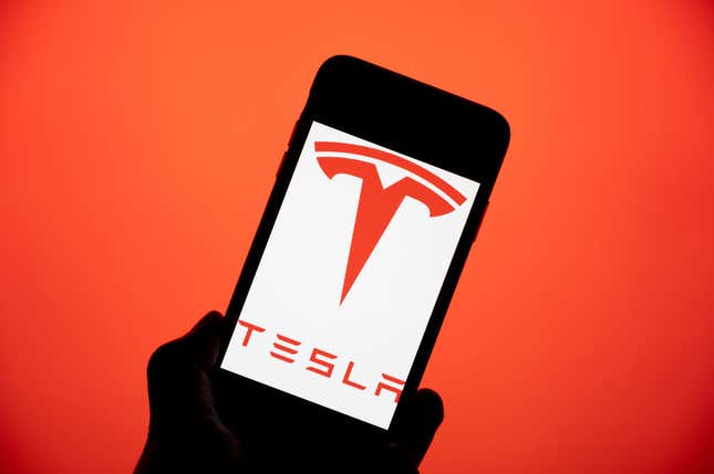 An Iphone with the Tesla logo on the screen