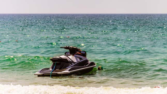 A jet-ski moored on a beach.