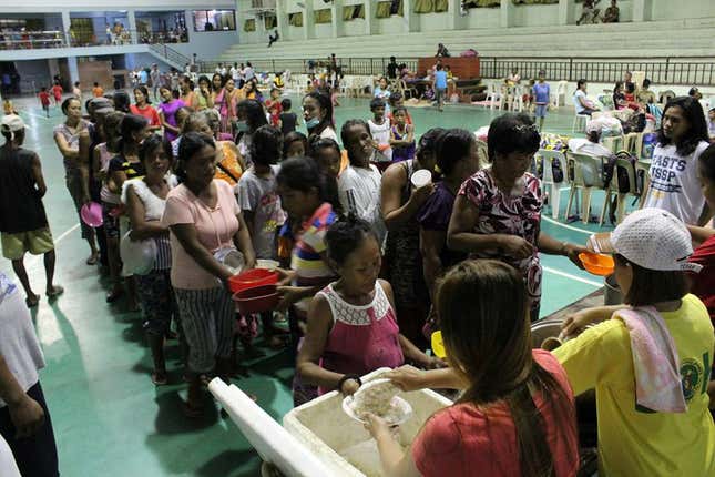 People are seen inside an evacuation centre in preparation for Typhoon Mangkhut in Cagayan, Philippines, in this September 13, 2018 photo by LGU Gonzaga Cagayan from social media.