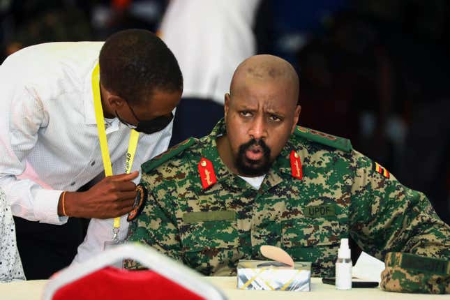 Then Lt. Gen. Muhoozi Kainerugaba, right, son of Uganda’s President Yoweri Museveni, speaks to Attorney General Kiryowa Kiwanuka, left, at a “thanksgiving” ceremony in Entebbe, Uganda on May 7, 2022. Uganda’s President Yoweri Museveni fired his son Muhoozi Kainerugaba as commander of the nation’s infantry forces Tuesday, Oct. 4, 2022 after the son tweeted an unprovoked threat to capture the capital of neighboring Kenya, drawing widespread concern in East Africa.