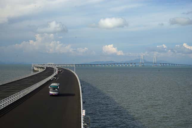 A bus crosses the Hong Kong-Zhuhai-Macau bridge in Zhuhai, Guangdong province, last year. The full bridge is not open yet.