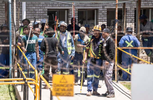 FILE - Mineworkers at the entrance of a goldmine in Springs, near Johannesburg, South Africa, Wednesday, Oct. 25, 2023. More than 2,000 workers have remained underground Tuesday, Dec. 19 in two shafts at Implats’ Bafokeng Rasimone Platinum Mine in the North West province of South Africa for a second day in a protest over pay and benefits. There were two recent underground protests at a gold mine in the city of Springs, near Johannesburg, one in October and one earlier this month. On both occasions, hundreds of mineworkers remained underground for days amid allegations some were holding others hostage in a dispute over which union should represent them. (AP Photo, file)