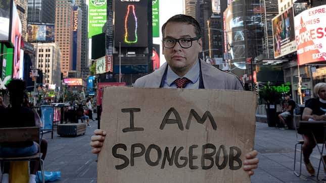 Image for article titled Unemployed George Santos Stands In Times Square With Sign Reading ‘I Am SpongeBob’