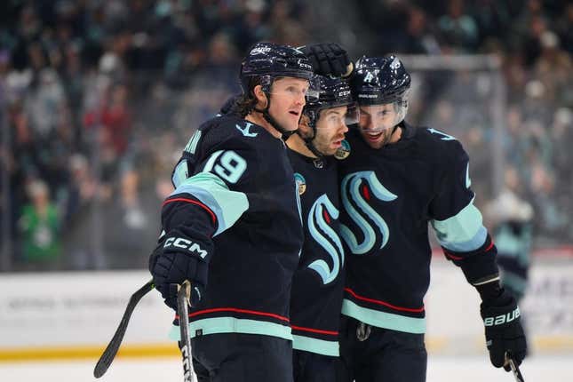 Nov 2, 2023; Seattle, Washington, USA; Seattle Kraken left wing Jared McCann (19), right wing Oliver Bjorkstrand (22) and defenseman Justin Schultz (4) celebrate after Bjorkstrand scored a goal against the Nashville Predators during the first period at Climate Pledge Arena.