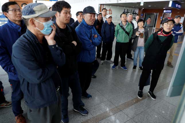 People watch a TV showing a live broadcast of the Korea summit at a railway station in Seoul, South Korea.