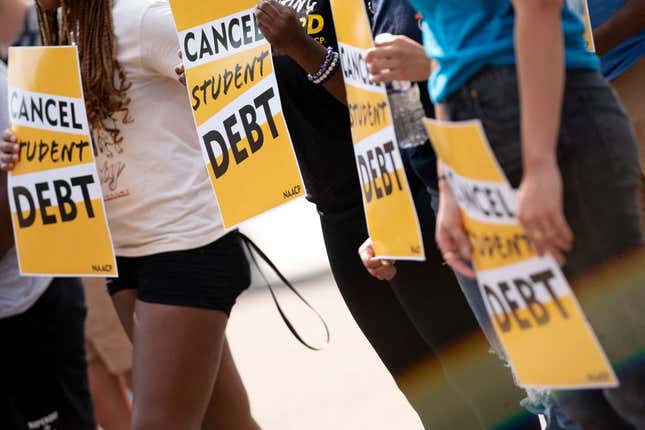 Activists hold cancel student debt signs as they gather to rally in front of the White House in Washington, DC, on August 25, 2022. - Biden announced on August 24, 2022, that most US university graduates still trying to pay off student loans will get $10,000 of relief to address a decades-old headache of massive educational debt across the country.