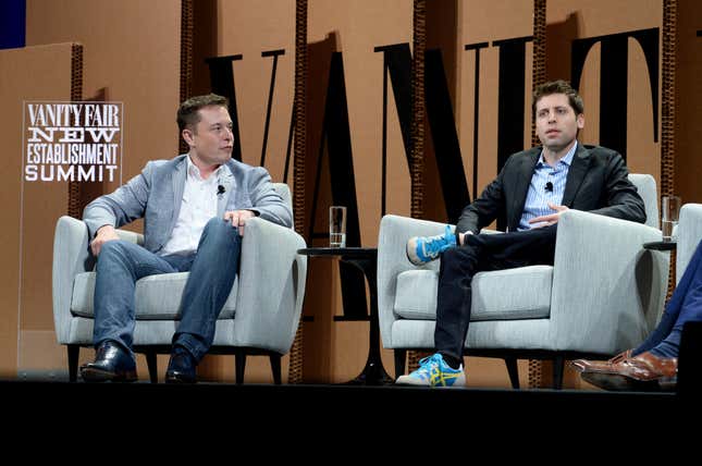 Elon Musk y Sam Altman sentados en sillones grises frente a un fondo marrón con letras negras gigantes y un cartel blanco que dice Vanity Fair New Establishment Summit