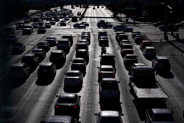 FILE - Cars wait at a red light during rush hour, April 22, 2021, in Las Vegas. Motor vehicles with higher, more vertical front ends are the most dangerous to pedestrians, according to a highway safety organization. (AP Photo/John Locher, File)