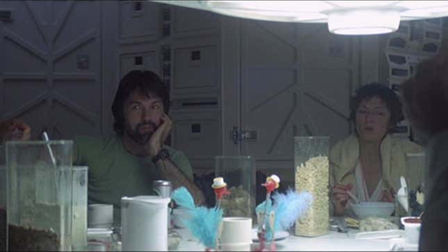 Nostromo crew eat around a white table with cereal on it