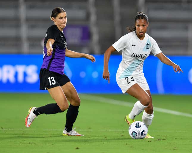 Margaret Purce #23 of the NJ/NY Gotham FC dribbles away from Alex Morgan #13 of the Orlando Pride during a game between NJ/NY Gotham City FC and Orlando Pride at Exploria Stadium on October 9, 2021 in Orlando, Florida.