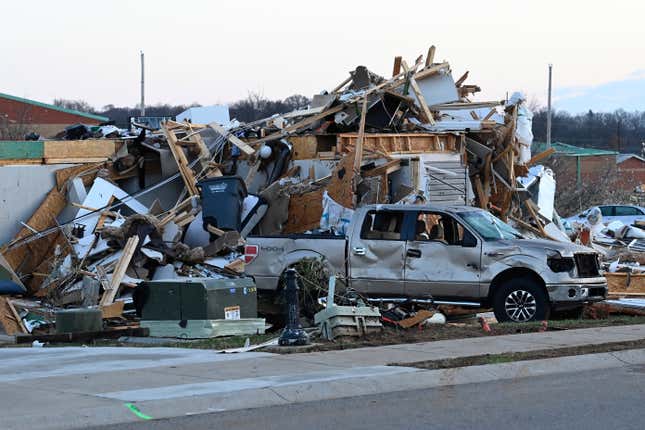 FILE - A damaged car sits by homes destroyed from severe weather in the West Creek Farms neighborhood on Sunday, Dec. 10, 2023, Clarksville, Tenn. If your home was hit by high water or a fire emergency, would your important papers be safe? Items like insurance information, birth and marriage certificates, passports, Social Security cards and estate planning paperwork should all be protected in case the worst happens. (AP Photo/Mark Zaleski, File)