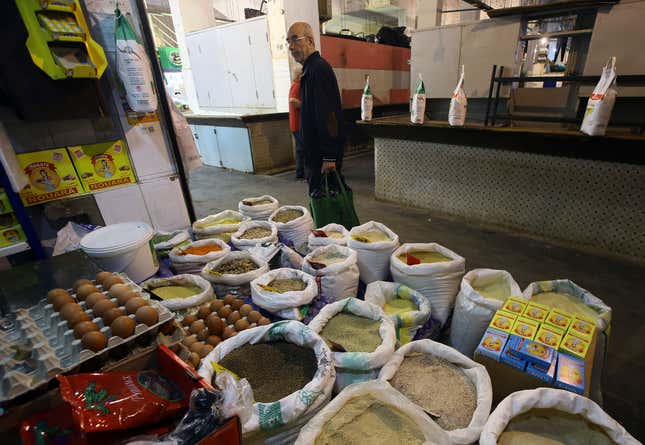 A man stands by food bags in a market near Algiers, Tuesday, March 26, 2024. As Muslim-majority countries reckon with increased demand throughout Islam&#39;s holy month of Ramadan, is trying to flood new markets with pantry staples to stave off shortages that can cause prices to rise. (AP Photo/Anis Belghoul)