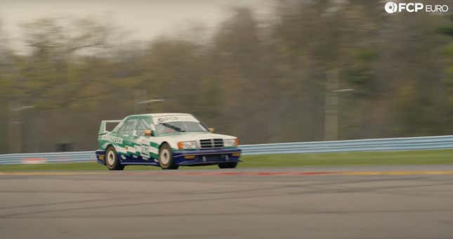 A green, white and blue Mercedes Benz 190e race car drives on the track at Watkins Glen