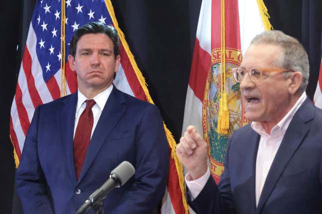 Florida Gov. Ron DeSantis listens to Central Florida Tourism Oversight District board chairman Martin Garcia, right, deliver remarks during a news conference at CFTOD headquarters at Walt Disney World, in Lake Buena Vista, Fla., Feb. 22, 2024. The shake-up of Walt Disney World&#39;s governing district more than a year after it was taken over by Gov. DeSantis&#39; appointees continued Wednesday, March 13, 2024 with the departure of its board chairman who had been highly critical of Disney. Garcia&#39;s departure as chairman is coming a week after the district&#39;s administrator, Glen Gilzean, left to accept an appointment by DeSantis as interim elections supervisor in Orange County, the home of Orlando, at half the salary. (Joe Burbank/Orlando Sentinel via AP, file)