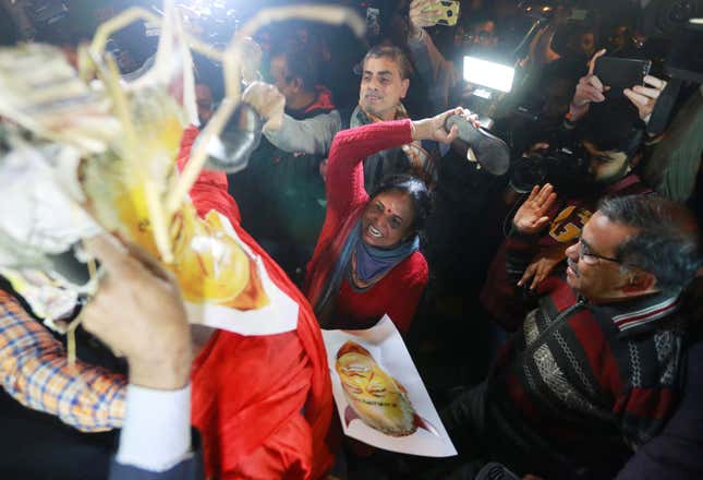 In New Delhi, protesters beat an effigy of Vijayan.