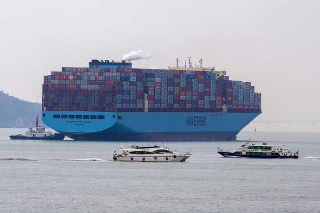 Ferries sail by a containers vessel prepares to dock at a port in Xiamen in southeast China&#39;s Fujian province on Dec. 27, 2023. China&#39;s exports grew slightly for a second consecutive month in December even as deflationary pressures continue, according to official data released Friday, Jan. 12, 2024 underscoring an uneven recovery in 2023. (AP Photo/Andy Wong)