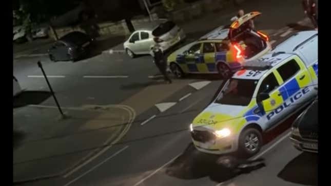 A photo of a police car crashing into a cow. 