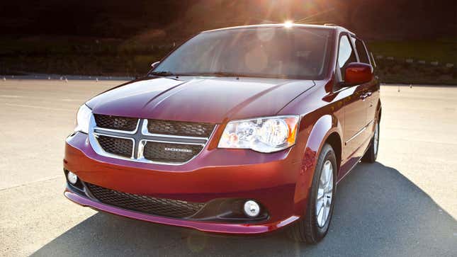 A photo of a red Dodge Grand Caravan with the sun glinting on