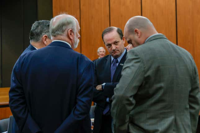 South Carolina Attorney General Alan Wilson, facing, speaks with members of his staff during a break in a hearing on a motion for Alex Murdaugh&#39;s retrial, Tuesday, Jan. 16, 2024, at the Richland County Judicial Center in Columbia, S.C. Murdaugh was convicted of killing his wife, Maggie, and younger son, Paul, in June 2021. (Tracy Glantz/The State via AP, Pool)