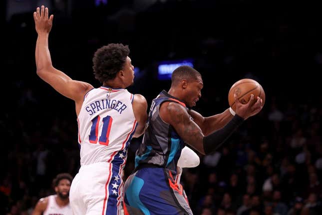 Nov 19, 2023; Brooklyn, New York, USA; Brooklyn Nets guard Lonnie Walker IV (8) grabs a rebound against Philadelphia 76ers guard Jaden Springer (11) during the first quarter at Barclays Center.