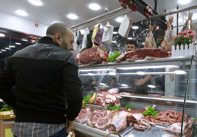 People shop for beef at a butchery in Algiers, Algeria, Sunday, Feb. 18, 2024. Algeria is importing massive amounts of beef and lamb to confront an explosion in demand for meat expected throughout the Muslim holy month of Ramadan, hoping to stabilize prices as the country&#39;s economy continues to struggle. The oil-rich North African nation is among countries working to import food and fuel, hoping to meet the requirements of Algerians preparing nightly feasts as their families break their sunrise-to-sunset fasts. (AP Photo/Fateh Guidoum)