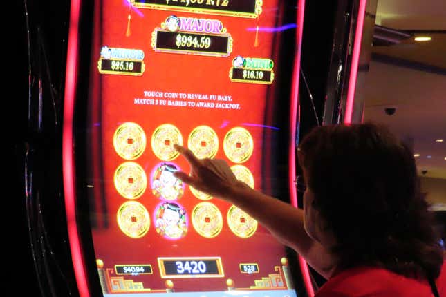 A gambler touches the screen of a slot machine at Harrah&#39;s casino in Atlantic City N.J., Sept. 29, 2023. Figures released, Tuesday, April 16, 2024, show Atlantic City&#39;s casinos, their online partners and horse tracks that take sports bets won over $526 million in March, a month in which New Jersey&#39;s internet gambling market set yet another monthly record at $197 million. (AP Photo/Wayne Parry)