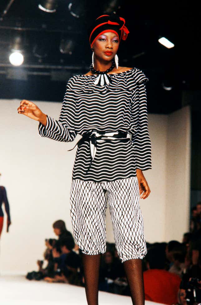 Model Mounia Orosemane walks in the Yves Saint Laurent Spring 1980 Ready to Wear Runway Show on October 16, 1979, in Paris France. 