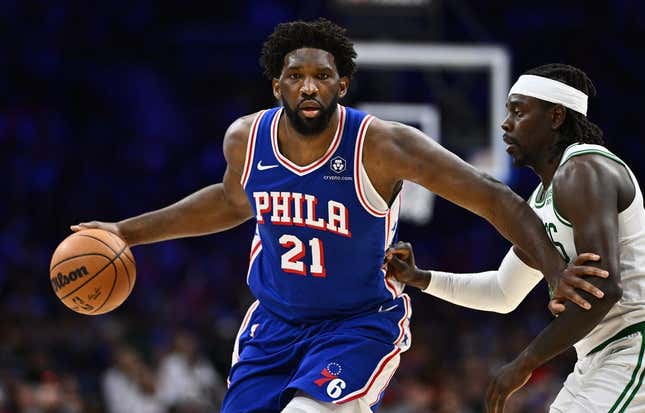 Nov 8, 2023; Philadelphia, Pennsylvania, USA; Philadelphia 76ers center Joel Embiid (21) drives against Boston Celtics guard Jrue Holiday (4) in the fourth quarter at Wells Fargo Center.