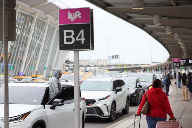 People wait for cars in the Lyft pick-up area at JFK Airport on April 28, 2023 in New York City